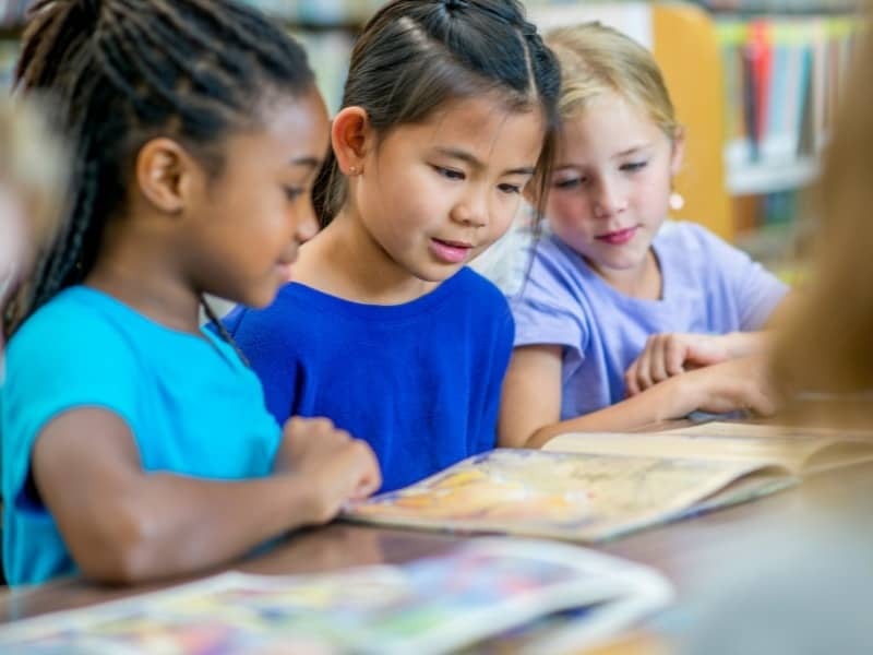 Young students reading together in class.