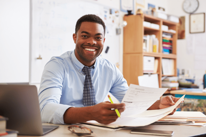 A teacher looking at student work to make planning decisions for his math classroom. 
