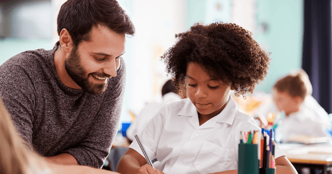 Teacher and student working on math problem.